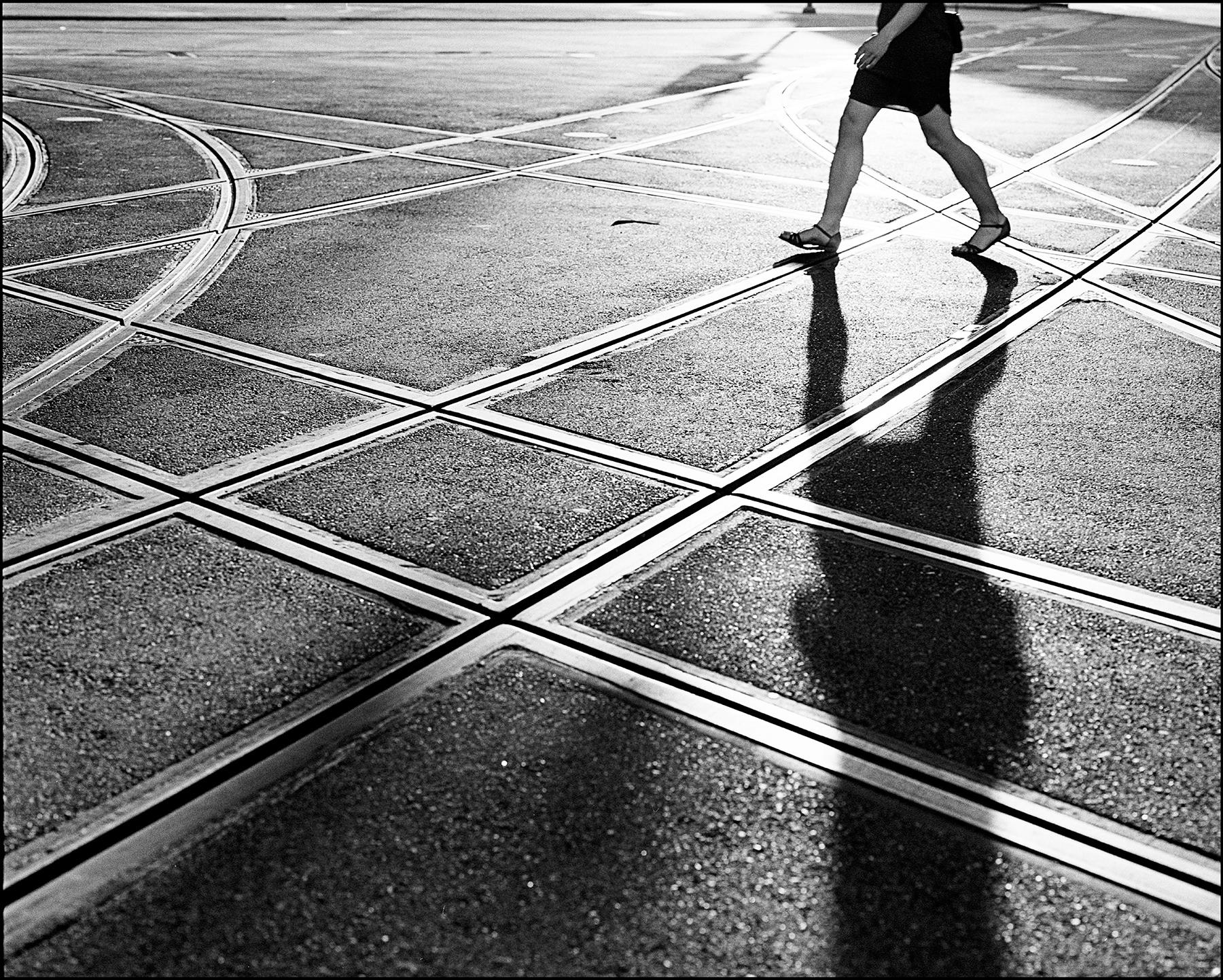 a woman crossing a street